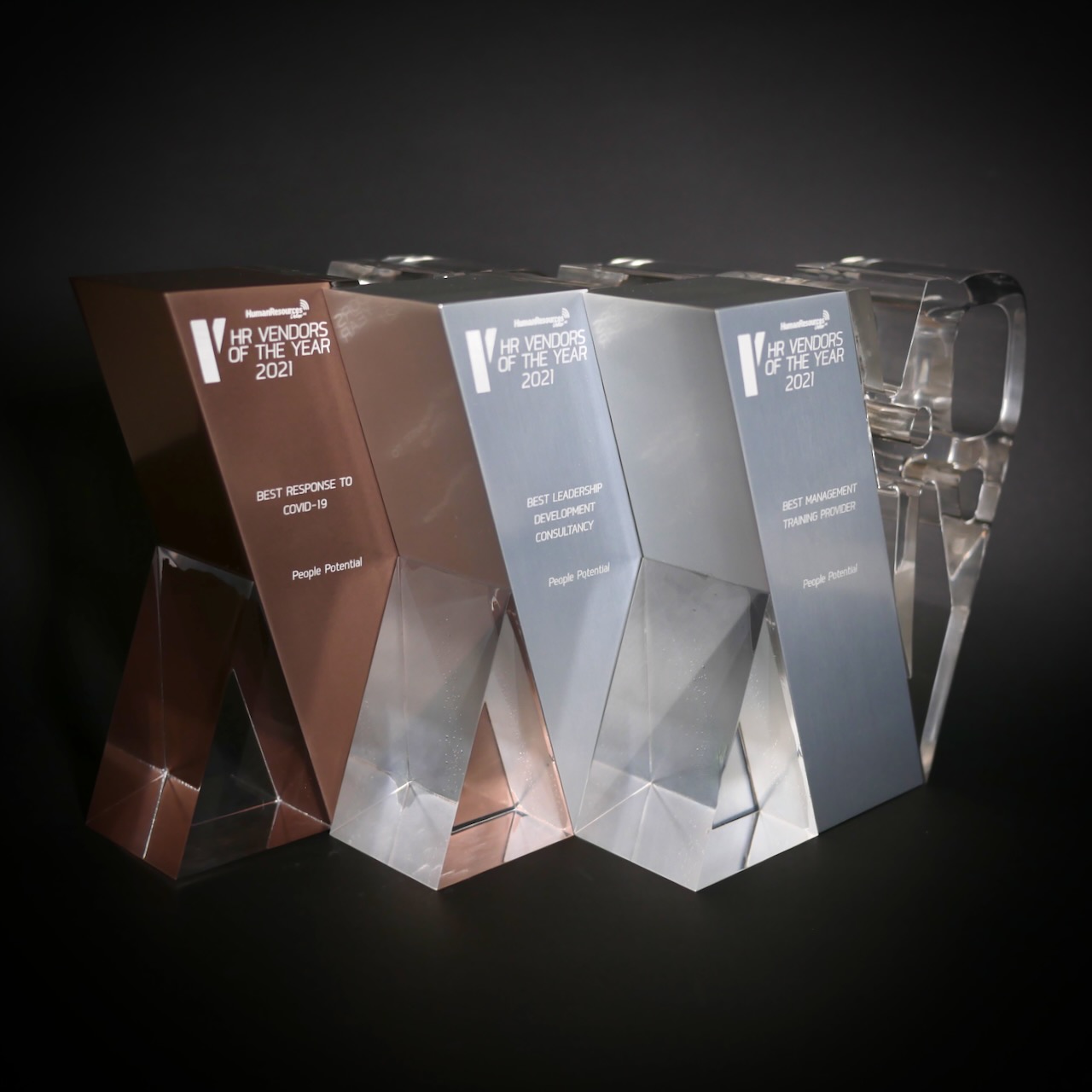 A gold and two silver trophies from HR Vendors of the Year 2021
